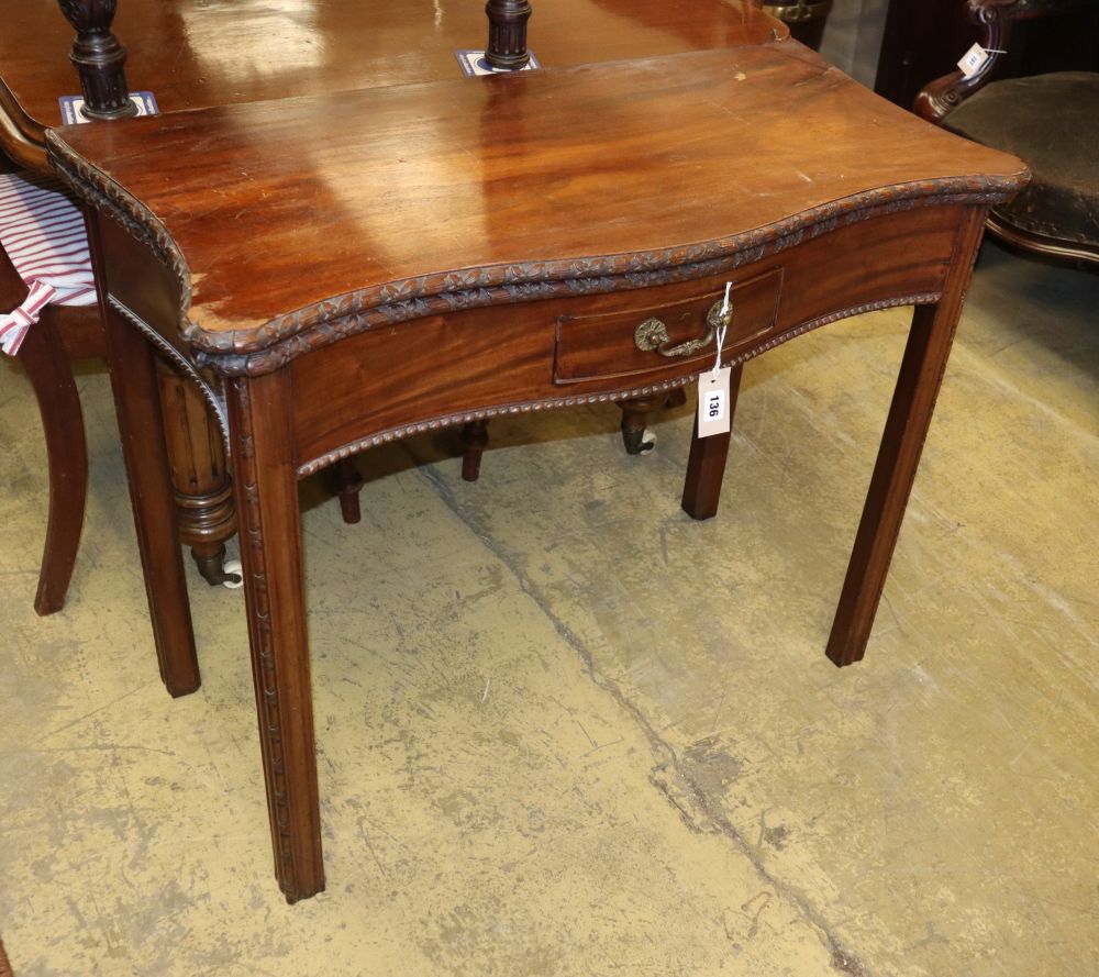 A George III style carved mahogany serpentine tea table with folding top, W.90cm, D.46cm, H.74cm
